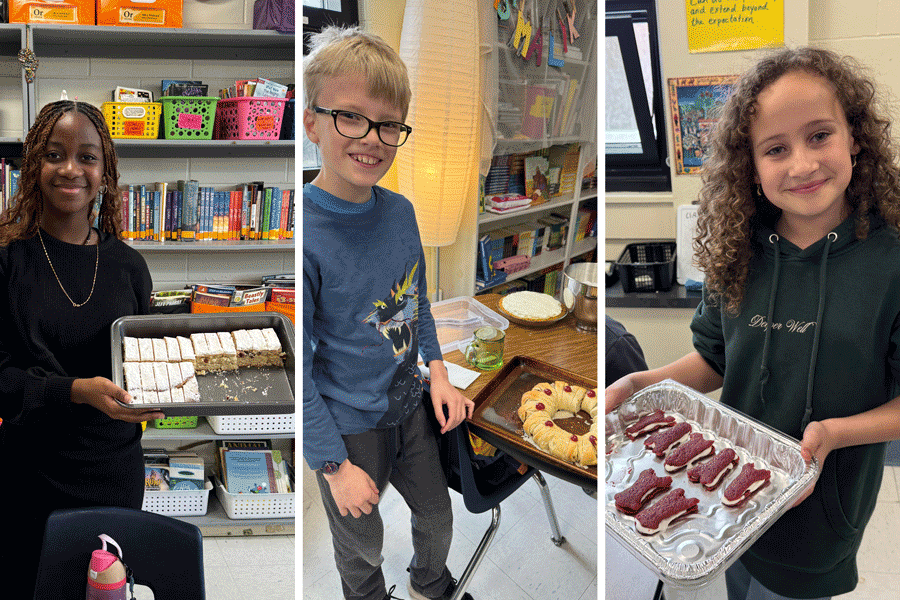 Three students in a classroom setting, each holding different trays of desserts. 