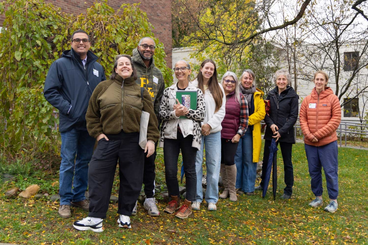 A group of people gather in front of a school.