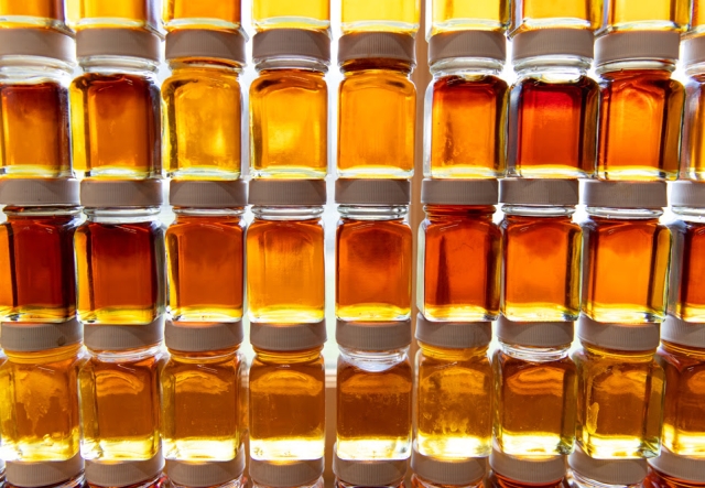 small sample bottles of various grades of maple syrup